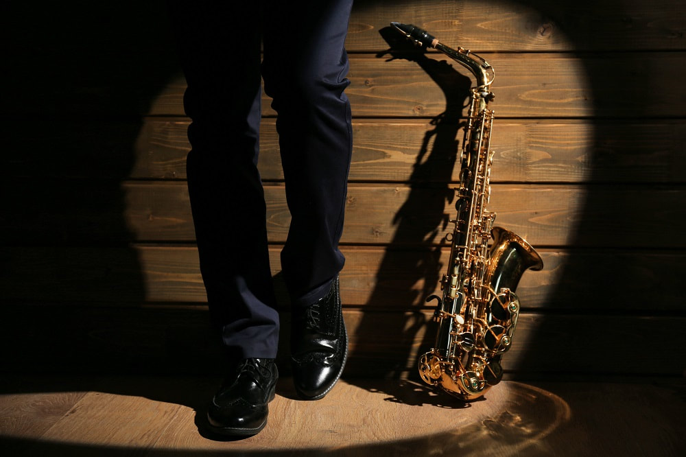 Musician standing with Sax_blog title_hire a saxophonist for your special occasion