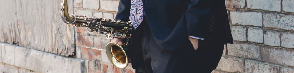 Photo of man holding a saxophone